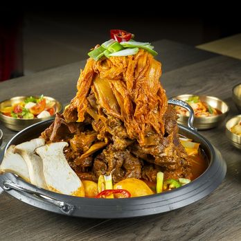 Chef ladling Korean tang broth